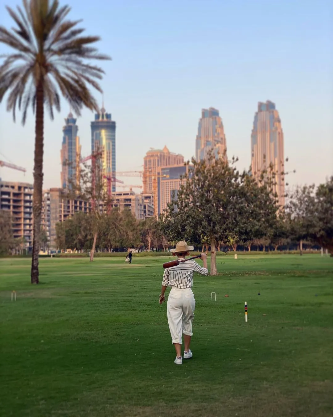 Stylish woman playing croquet