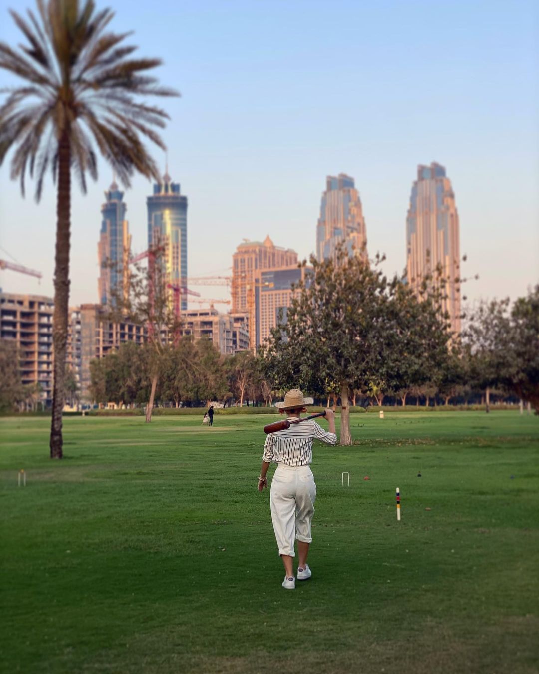 stylish woman playing croquet